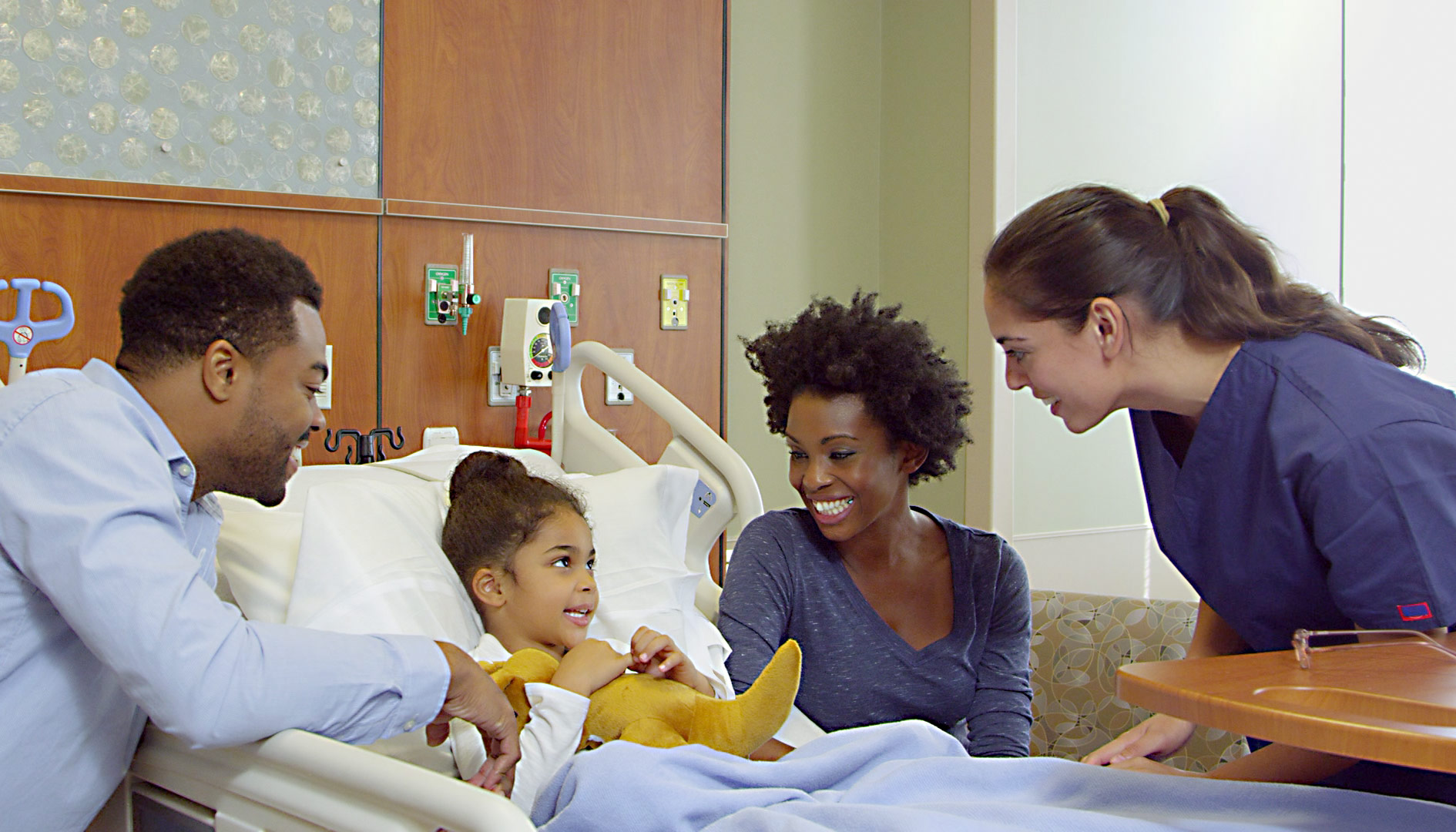 Pediatric patient with parents and nurse in hospital