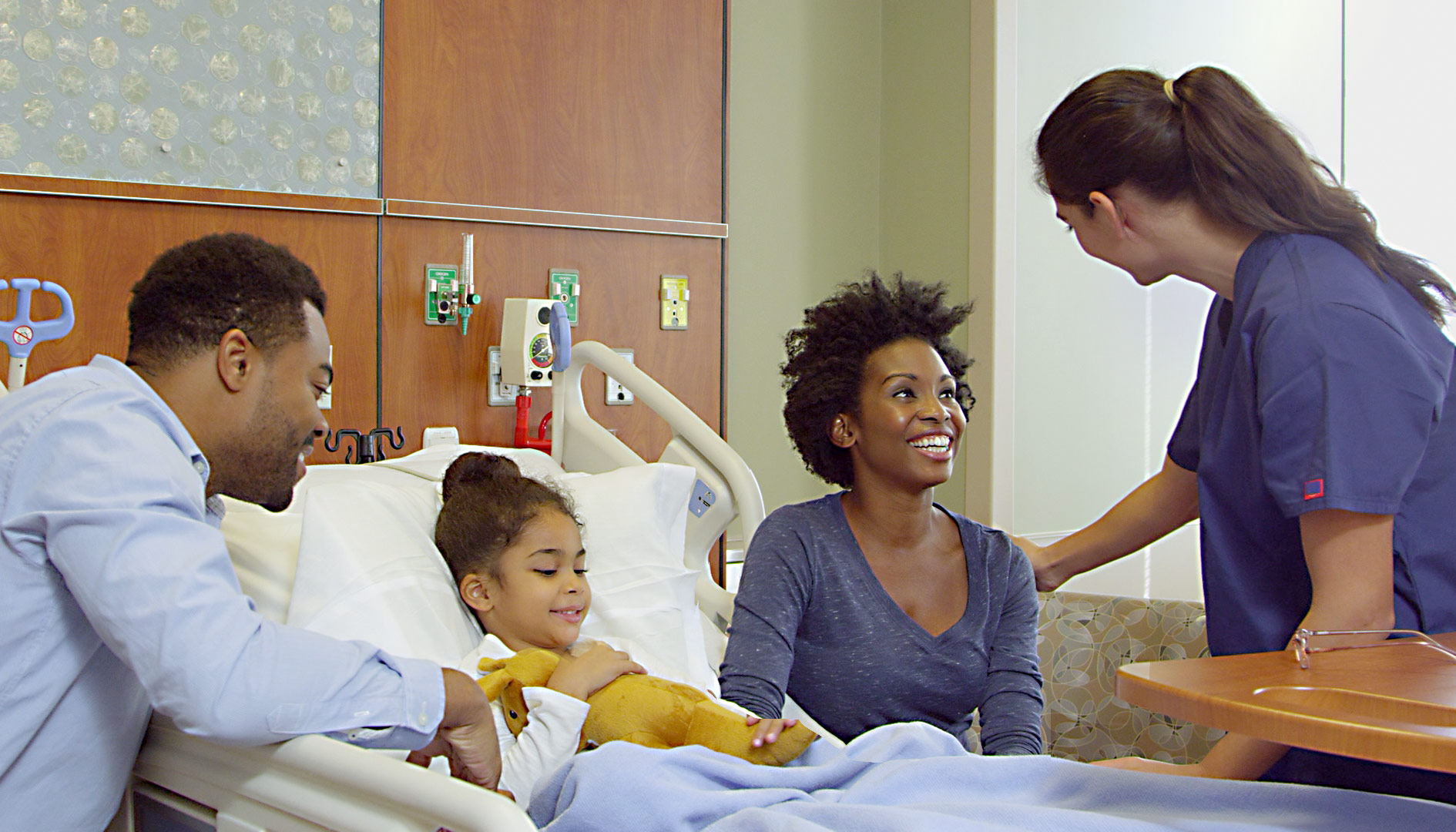Pediatric patient with parents and nurse in hospital