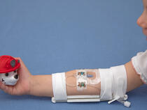 Toddler wearing I.V. House TLC® Elbow Splint