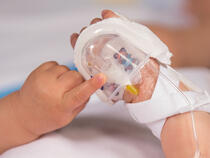 330L I.V. House UltraDressing on infant's hand