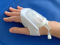 730M I.V. House UltraDressing protects I.V. insertion site on adult's hand